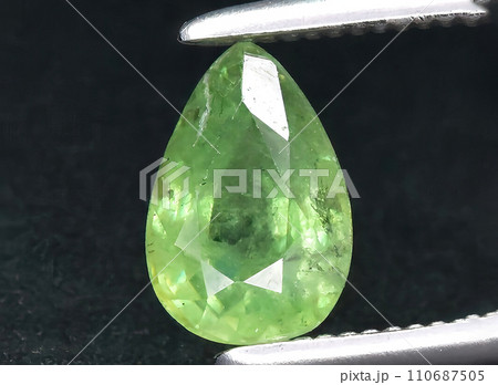 natural green demantoid garnet gem on the background 110687505