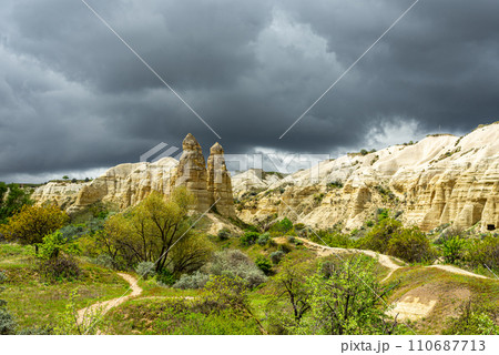 Unique geological formations in the Valley of Love in Cappadocia with a stormy sky Unique geological formations in the Valley of Love in Cappadocia with a stormy sky 110687713