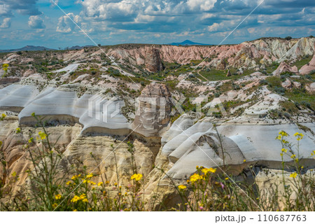 Martian landscape in Cappadocia, unique relief of mountains painted in yellow and pink colors Martian landscape in Cappadocia, unique relief of mountains painted in yellow and pink colors 110687763