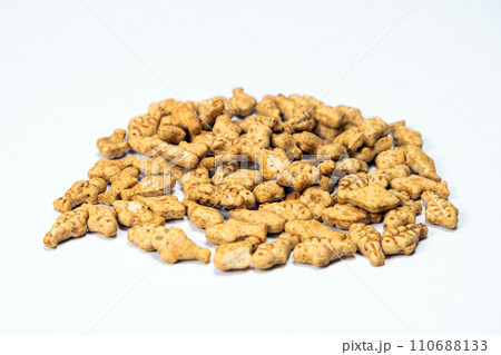 A treat for cats and kittens is a fish-shaped catnip cookie close-up. A treat for cats and kittens is a fish-shaped catnip cookie close-up. 110688133