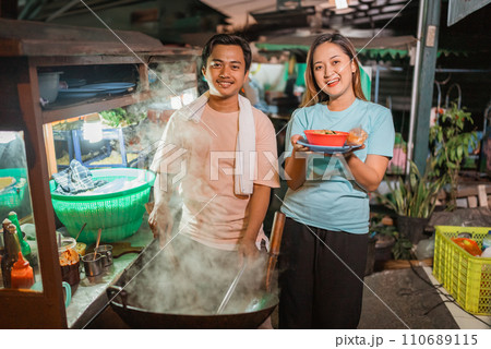 asian male and woman selling fried rice asian male and woman selling fried rice 110689115