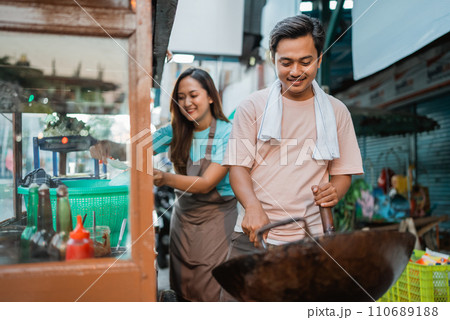 asian male seller frying rice using wok 110689188
