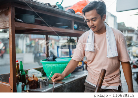 indonesian man cooking delicious fried rice indonesian man cooking delicious fried rice 110689218
