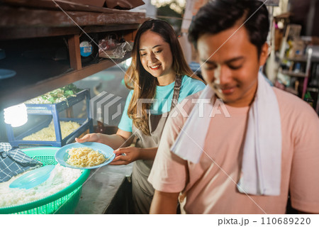 woman holding plate of noodle to cook fried rice woman holding plate of noodle to cook fried rice 110689220