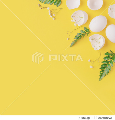 White Easter eggs and shells on a bright yellow background. 110690058