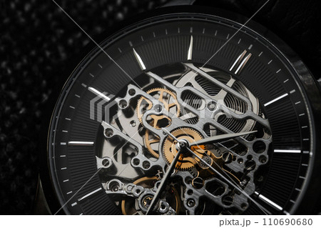 Macro photo of mechanic skeleton watch. Black clock face 110690680