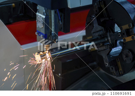 Close up scene the fiber laser cutting machine cut the stainless steel tube and sparkling light. Close up scene the fiber laser cutting machine cut the stainless steel tube and sparkling light. 110691691