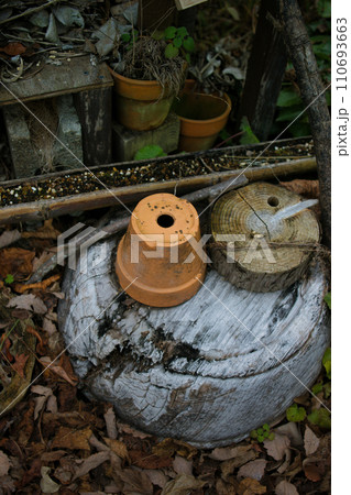 庭先に置かれた使われなくなった古い植木鉢 110693663