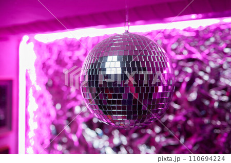 Disco ball with bright rays, night party background photo 110694224