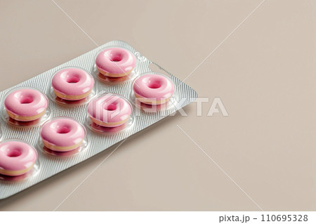 Pill blister with donuts instead of pills. Sugar addiction, diabetes, obesity, overweight, weight loss medical treatment. Unhealthy food, anti-stress comfort food, sweet drugs, medicaments and sweets 110695328