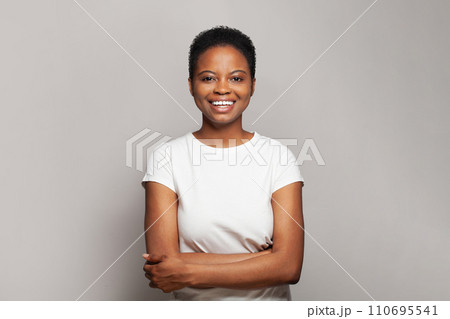 Confident happy woman smiling and having fun against white studio wall background Confident happy woman smiling and having fun against white studio wall background 110695541