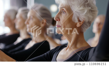 AI-generated content. Group of Older Women Sitting in a Row on Exercise Bikes 110696151