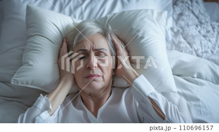 AI-generated content. Woman in Bed, Head in Hands, Resting, Tired, Relaxing, Sleep, Bedroom, Restlessness, Stress 110696157