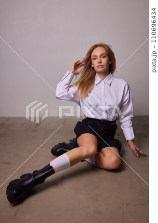 High fashion photo of a beautiful elegant young woman in a pretty beige suit High fashion photo of a beautiful elegant young woman in a pretty beige suit 110696434