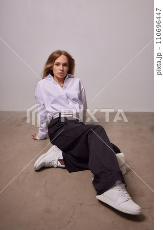 High fashion photo of a beautiful elegant young woman in a pretty beige suit High fashion photo of a beautiful elegant young woman in a pretty beige suit 110696447