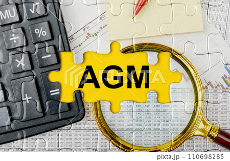 Puzzle with a calculator, magnifying glasses and financial documents in the center inscription -AGM Puzzle with a calculator, magnifying glasses and financial documents in the center inscription -AGM 110698285