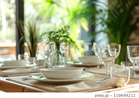 Dinner table setting of four with plants in the background. Generative AI Dinner table setting of four with plants in the background. Generative AI 110699212
