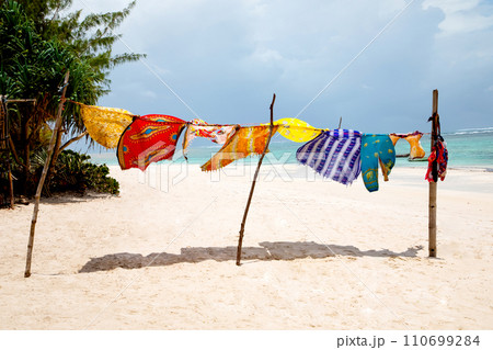 A group of primary colored t-shirts on a clothesline in front of blue sky A group of primary colored t-shirts on a clothesline in front of blue sky 110699284