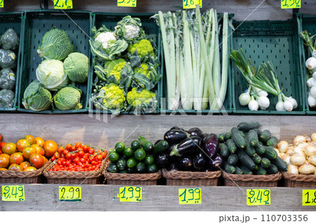 Large assortment of freshly harvested vegetables showcased on display in supermarket Large assortment of freshly harvested vegetables showcased on display in supermarket 110703356