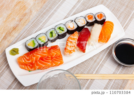 On table there portion set with maki, sashimi and nigiri On table there portion set with maki, sashimi and nigiri 110703384