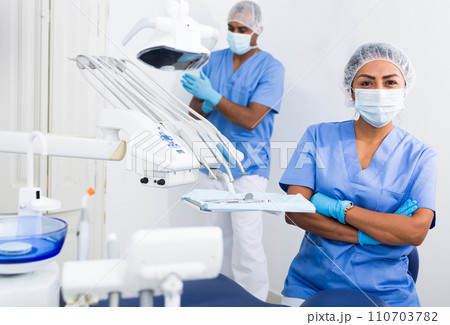 Nurse prepares instruments before the patient is seen by dentist 110703782
