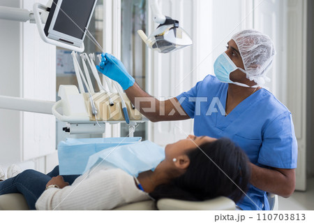 Dentist discussing treatment procedures with female patient Dentist discussing treatment procedures with female patient 110703813