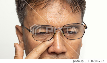 Senior man eyestrain after for long stretches at computer or digital screens. Senior man eyestrain after for long stretches at computer or digital screens. 110706723