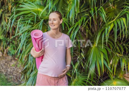 Energetic pregnant woman takes her workout outdoors, using an exercise mat for a refreshing and health-conscious outdoor exercise session Energetic pregnant woman takes her workout outdoors, using an exercise mat for a refreshing and health-conscious outdoor exercise session 110707077