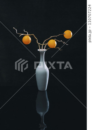 Still life with orange balls in a white vase Still life with orange balls in a white vase 110707224