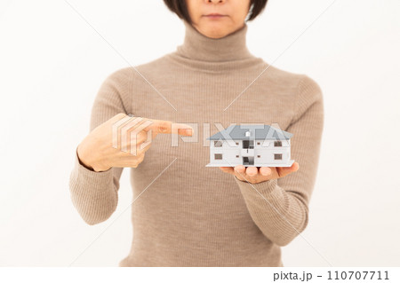 マンションの住宅模型を持つミドル女性 マンションの住宅模型を持つミドル女性 110707711