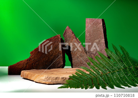 Stone display for product against green background 110710818