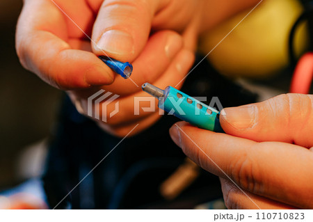 Male hands holding syringe with thermal paste close up Male hands holding syringe with thermal paste close up 110710823