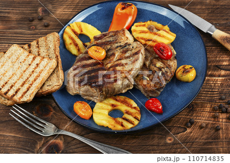 Pork steak with pineapple on plate. Pork steak with pineapple on plate. 110714835