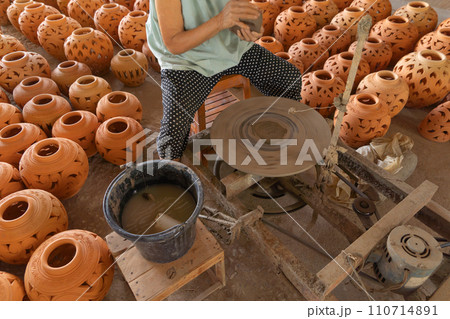 Earthenware earthen pot or a clay pot bowl. Traditional old local woman. People lifestyle. Earthenware earthen pot or a clay pot bowl. Traditional old local woman. People lifestyle. 110714891