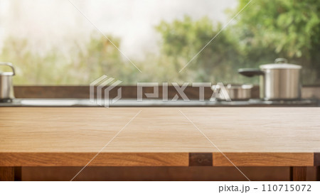 Wooden table over blurred kitchen window sill for product display. Wood table top on blur kitchen room. product presentation background or branding with bright wood counter. Kitchen interior 110715072