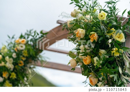 Beautiful wooden wedding arch decorated with flowers 110715843