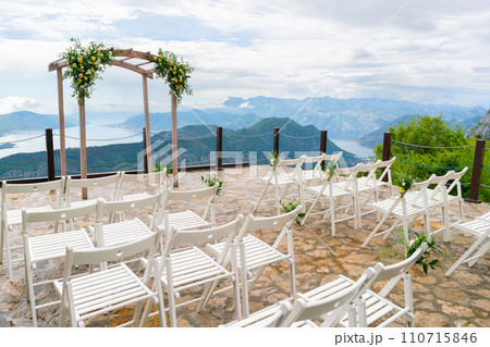 Beautiful wooden wedding arch decorated with flowers Beautiful wooden wedding arch decorated with flowers 110715846