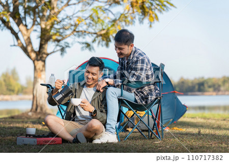Happy Asian male gay couple on camping together in a forest. romantic vocation trip. lgbt concept 110717382