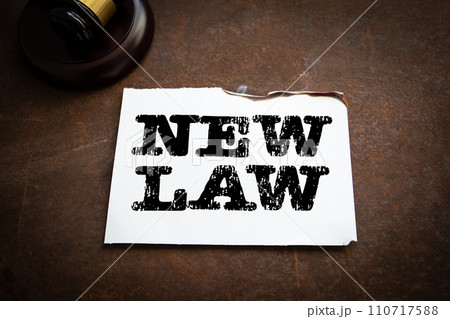 New Law Concept. Text on a piece of paper, rusty metal background New Law Concept. Text on a piece of paper, rusty metal background 110717588