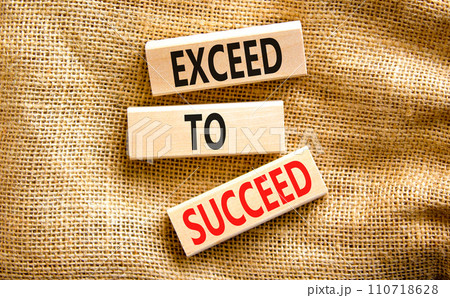 Exceed to succeed symbol. Concept words Exceed to succeed on beautiful wooden blocks. Beautiful canvas table canvas background. Business and exceed to succeed concept. Copy space. 110718628