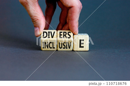 Diverse and inclusive symbol. Concept word Diverse and Inclusive on wooden cubes. Beautiful grey table grey background. Businessman hand. Business diverse and inclusive concept. Copy space. 110718676