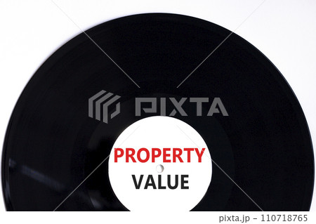 Property value symbol. Concept words Property value on beautiful black vinyl disk. Beautiful white table white background. Business property value concept. Copy space. Property value symbol. Concept words Property value on beautiful black vinyl disk. Beautiful white table white background. Business property value concept. Copy space. 110718765