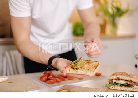 Spread pesto on roasted slice of baguette. Middle selection. Italian food Spread pesto on roasted slice of baguette. Middle selection. Italian food 110720112