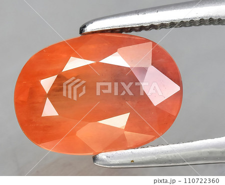 natural orange sapphire gem on the background natural orange sapphire gem on the background 110722360