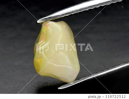 natural multi color rainbow opal gem on the background 110722512