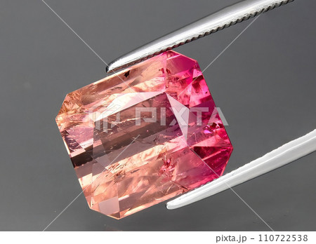 natural bi color tourmaline gem on the background natural bi color tourmaline gem on the background 110722538