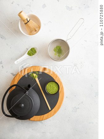 Japanese iron kettle with matcha green tea powder with whisk and spoon and bowl with sifter 110725880