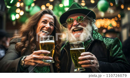 AI-generated content. Modern adult man with a beard and a woman in green glasses drink beer and joyfully celebrate St. Patrick's Day 110726079