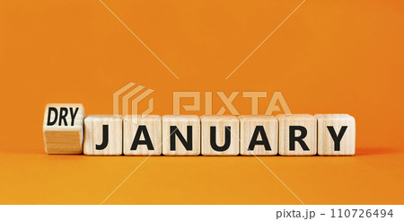 Dry January challenge symbol. Concept words Dry January on beautiful wooden cubes. Beautiful orange table orange background. Dry January healthy lifestyle concept. Copy space. 110726494