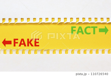 Fact or fake symbol. Concept word Fake and Fact on beautiful yellow paper. Beautiful white paper background. Business and fact or fake concept. Copy space. Fact or fake symbol. Concept word Fake and Fact on beautiful yellow paper. Beautiful white paper background. Business and fact or fake concept. Copy space. 110726540